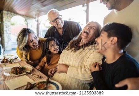 Happy Latin family having fun lunching together at home Royalty-Free Stock Photo #2135503889