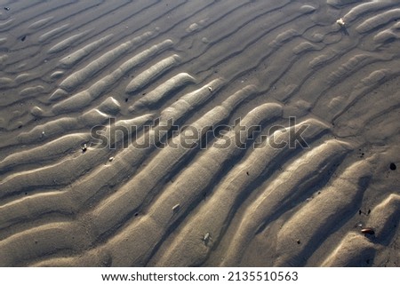 Abstract lines of sand on sea beach top view 