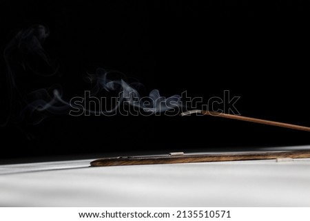 One incense stick on black and white background