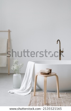 Cropped view of ceramic white bathtub with decor in modern bathroom interior design. Home spa concept. Time for yourself. Body care at home idea Royalty-Free Stock Photo #2135521165