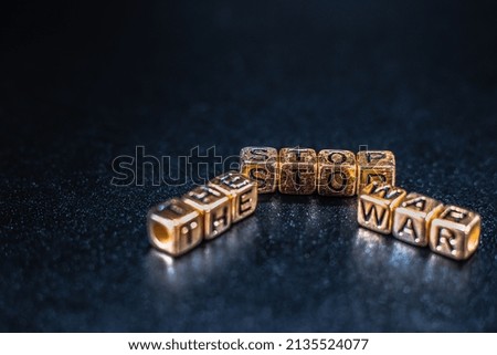 The word is placed on the table from cubes of letters to stop the war on a black background.