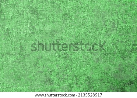 Textured green background with protrusions and dents, a surface of lines and spots