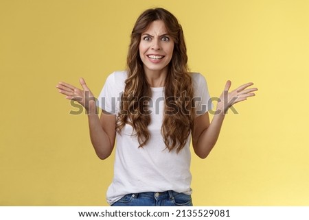Angry freaked out disappointed woman frowning grimacing anger distress raise hands sideways full dismay complaining being rude arguing look pissed outraged swearing frustrated yellow background Royalty-Free Stock Photo #2135529081