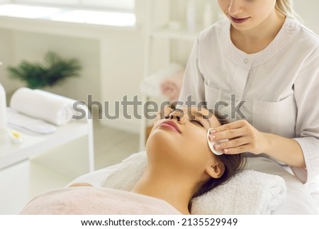 Close up of cosmetologist do beauty face procedures or treatment to woman client in aesthetic medicine clinic. Beautician doctor clean skin, make facial massage to patient. Cosmetology concept. Royalty-Free Stock Photo #2135529949