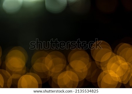 Romantic lights on Christmas decorations on black background. Defocused