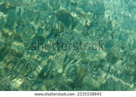 background of the calm blue-green sea on a sunny day