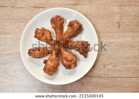 crispy fried chicken drum wing arranging on plate