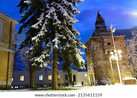 Winter landscape of the city of Vratsa, Bulgaria. Winter blue hour picture of stone clock tower of covered with snow city.
