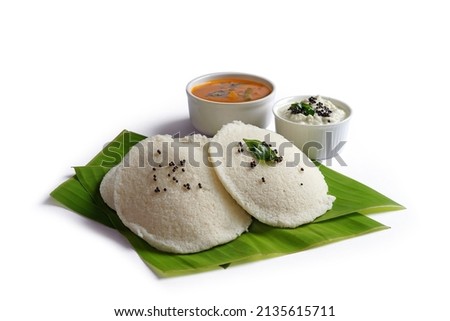South indian breakfast food idli with sambar and chutney on banana leaf. Isolated image with selective focus and shalow depth of field.           Royalty-Free Stock Photo #2135615711