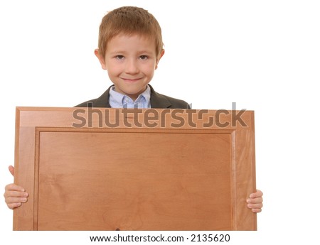 Young boy wearing suit holding blank wooden plaque