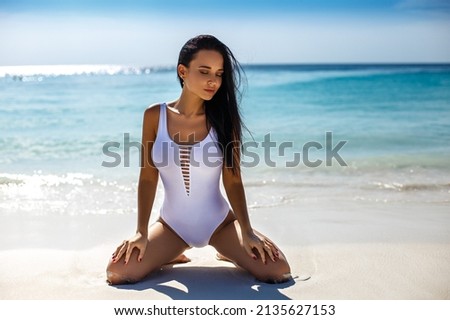 Perfect young girl in swimsuit on the beach