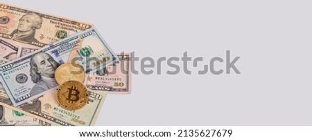 Banner with US dollars bills and bitcoin coins. Cryptocurrency at American money pile. Finance, savings, investment concept. Copyspace. High quality photo