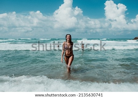 the girl comes out of the water to the shore