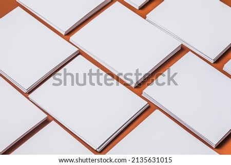 White sheet mockup. Stack of blank name cards. Blank white business card on brown paper background. 