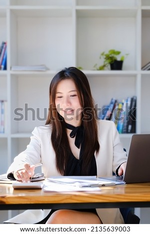 economists and accountants , data analysts are using calculators to calculate budgets and investments using statistical documents and computers to work at their desks. Royalty-Free Stock Photo #2135639003