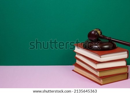 Law concept - law book with a wooden judges gavel on table in a courtroom or law enforcement office. Copy space for text 