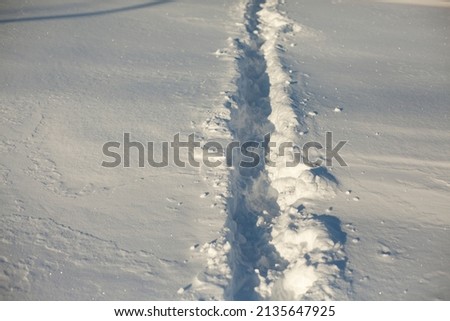 Path in snow. Path through deep snow. Traces from passage of tourists on snow cover.