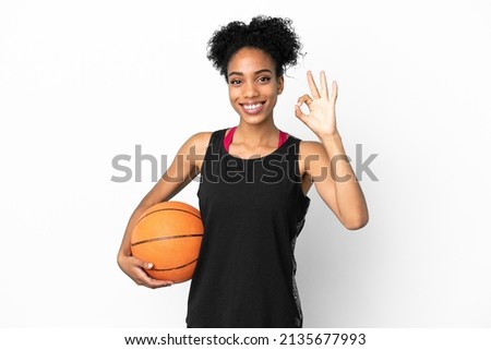 Young basketball player latin woman isolated on white background showing ok sign with fingers