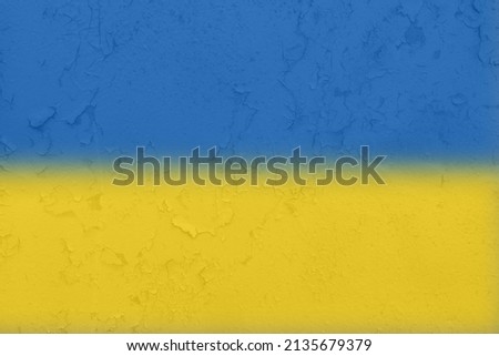 Ukrainian flag on a textured background. The flag of Ukraine on the old grunge wall in the background, the concept of destruction and war in Ukraine.Support for Ukrainians in the war with Russia