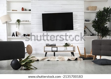 Chaotic living room interior after strong earthquake Royalty-Free Stock Photo #2135700183