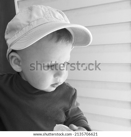Beautiful baby boy with child hat posing photographer for color photo, cadre consisting of baby boy in child hat, caucasian expression face, healthy baby boy in child soft hat relaxing for good shot