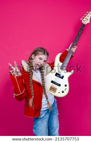 Expressive Caucasian Guitar Player With Yellow Bass Guitar Posing In Fashionable Fur Red Jacket With Shiny Instrument Shouting Over Trendy Pink Background. Vertical Orientation