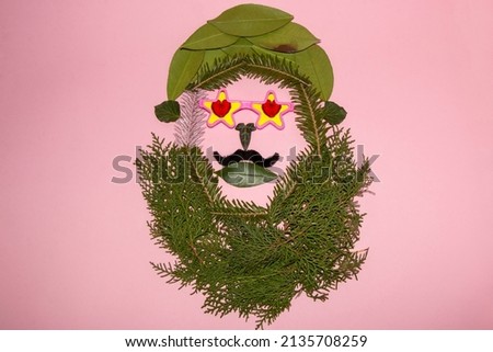 head of creatively arranged leaf, with short hair and a large beard, star-shaped glasses with a heart, mustache, natural hippie natural art background, copy space