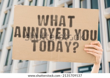 The question " What annoyed you today? " on a banner in men's hand with blurred background. Person. Anger. Adult. Angry. Mad. Rage. Sad. Upset. Crazy. Head. Fury. Loud. Hate. Office. Evil. Hater