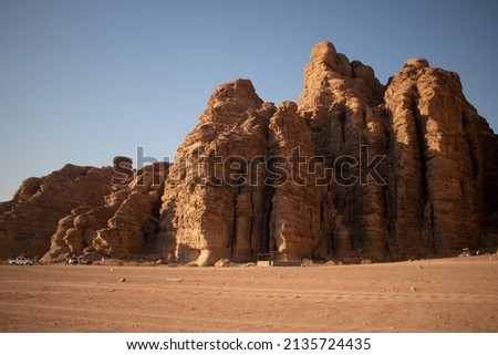 Wadi Rum Desert at Jordan. Beautiful desert with mountains, hills and cliffs.  Famous touristic attraction of Jordan. Royalty-Free Stock Photo #2135724435