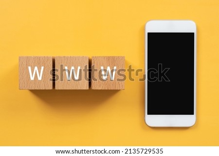 Wooden blocks with "WWW" text of concept and a smartphone.