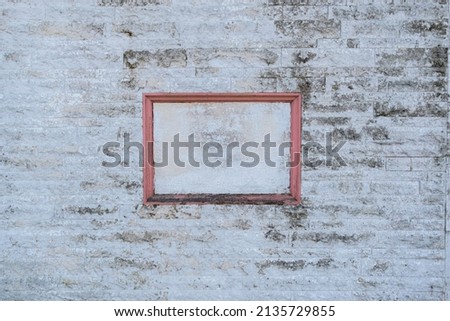 Texture map. Rotting pink wooden blank frame on dirty stone wall. Selective Focus. Background. Space for text.