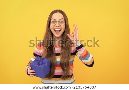 seasonal sales. amazed teen girl in eyeglasses with box. boxing day. present and gifts buy.