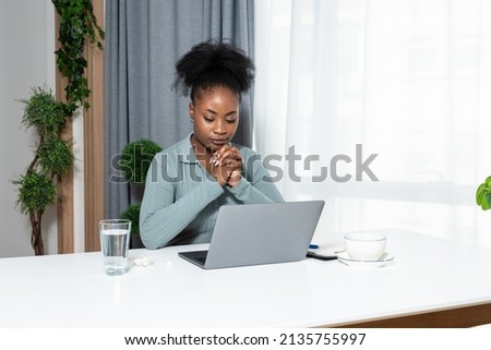 Young concentrated African American woman blogger and human rights activist writing a blog about cyber bullying and racism among young people through her personal negative experience. Royalty-Free Stock Photo #2135755997