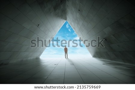 The figure of a man in a tunnel , background of bright light. Royalty-Free Stock Photo #2135759669