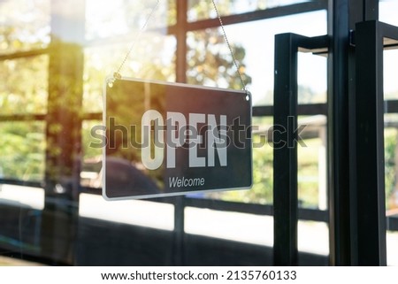 Open sign hanging front of cafe or restaurant. Sign with wording Welcome customer. Business service and food concept. 