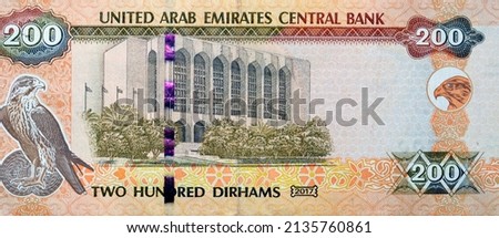 Large fragment of reverse side of 200 AED two hundred Dirhams banknote of United Arab Emirates that features the imagery of the Central Bank of the UAE and a falcon image, Emirates money banknote Royalty-Free Stock Photo #2135760861