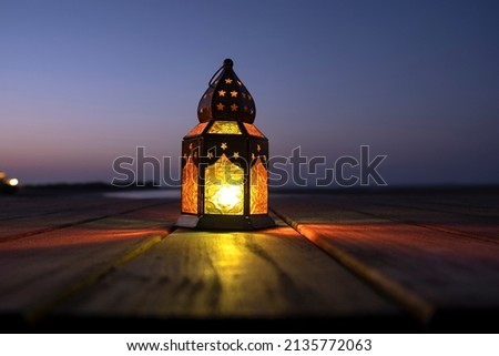 Ramadan lantern lit in the outdoor during a dusky evening. Royalty-Free Stock Photo #2135772063