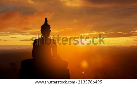 buddha silhouette on golden sunset background beliefs of Buddhism Royalty-Free Stock Photo #2135786495