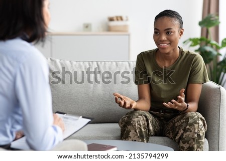 Happy Black Soldier Woman Talking To Female Therapist During Meeting In Office, Smiling African American Military Lady In Camouflage Uniform Speaking With Counselor After Successful Therapy Royalty-Free Stock Photo #2135794299