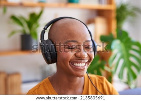 A close up of young woman listening to music with headphones