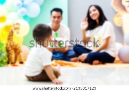blurred background of family celebrating kid's birthday party. best for happy family and birthday backgrounds.