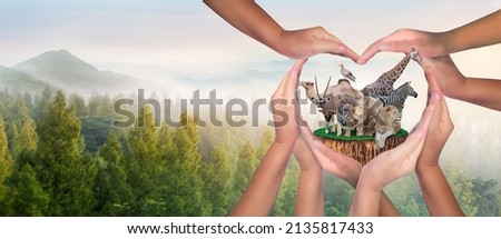 Wildlife Conservation Day. Or wildlife protection It's a diverse group of people who come together to build hands, hearts that connect to protect the environment. and promote conservation wildlife. Royalty-Free Stock Photo #2135817433