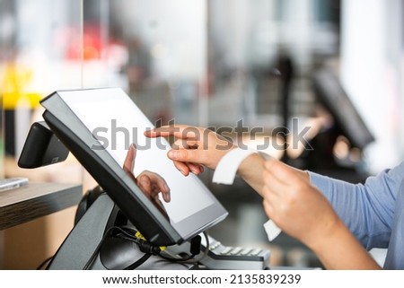 Concept of small business or sevice, woman or saleswoman in apron at counter with cashbox working at clothes shop, touchscreen POS, finance concept, business Royalty-Free Stock Photo #2135839239