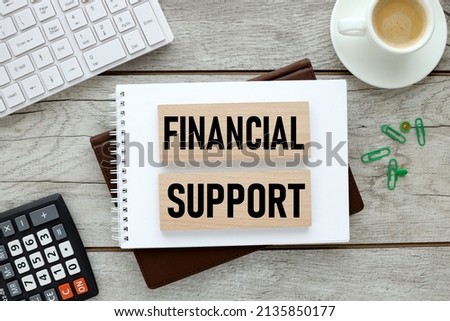 FINANCIAL SUPPORT text on wooden blocks on the diary