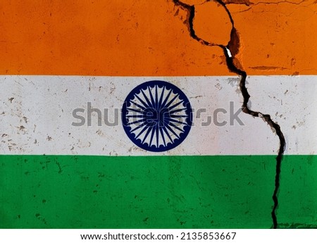 Indian flag on cracked wall.