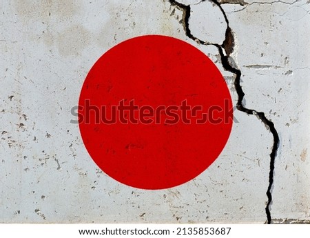 Japanese flag on cracked wall.