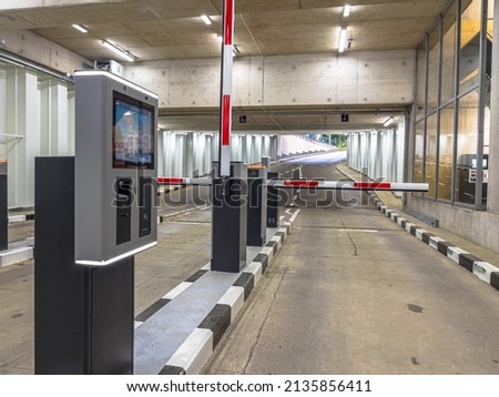 Barrier at Entrance and Exit of a car Parking garage. Fully automated barrier from car park. Underground parking, garage. Interior of parking Royalty-Free Stock Photo #2135856411