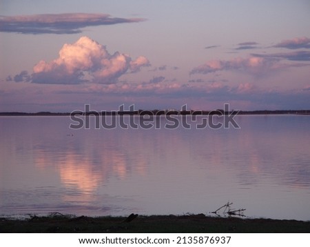 Clouds reflecting off flood water at sunset
