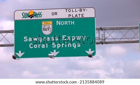 Street sign on the highway of Florida showing Coral Springs and Sawgrass Expressway Royalty-Free Stock Photo #2135884089