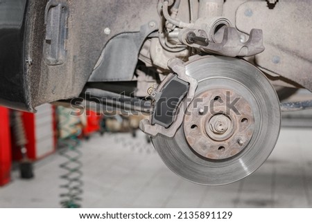 Disc brakes on cars in process of replacement in the garage or auto repair service center. Brake system of care, Closeup disc brake of the vehicle for repair in garage.